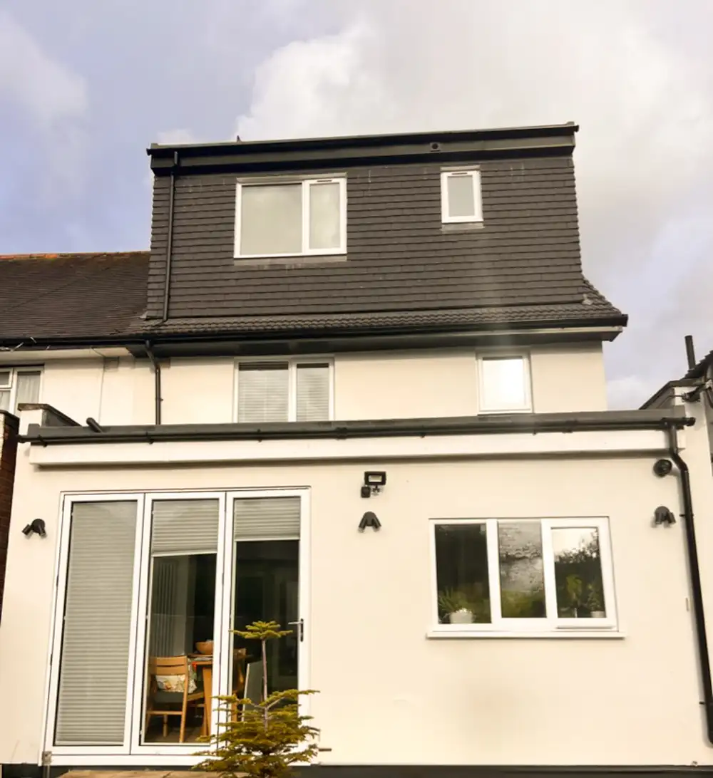 A finished loft dormer and new roof by M. Rose Construction